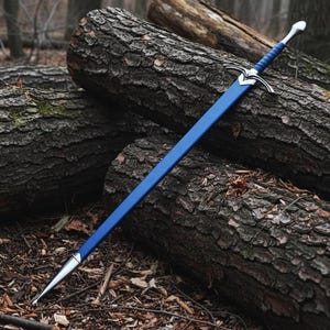 May include: A long sword with a blue scabbard and a matching blue wrapped handle. The sword features a silver-colored metal crossguard and a pointed pommel. The scabbard is finished with a silver-colored metal tip at the bottom end.