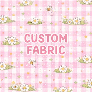 May include: Pink gingham pattern fabric with daisies, bees, and hearts. The words "CUSTOM FABRIC" are in pink, centered on the fabric. The fabric has a cute, whimsical design, perfect for crafting projects.