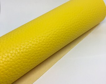 May include: A roll of bright yellow faux leather with a textured surface.