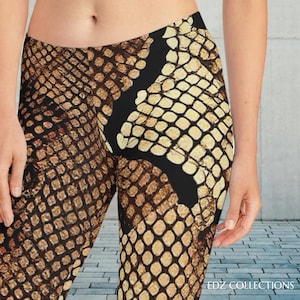 May include: Leggings with a snakeskin pattern in shades of brown and tan, featuring a black stripe down the side. The leggings have a textured appearance, mimicking the scales of a snake. The text "EDZ COLLECTIONS" is visible at the bottom right.