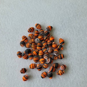 Orange paper beads to make handmade jewelry, recycled paper beads
