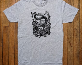 May include: A gray t-shirt with a black and white illustration of a snake wrapped around roses.