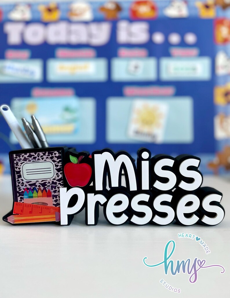 May include: Black and white desk organizer with a leopard print design. The organizer has a red apple, pencils, and a ruler. The text "Miss Presses" is in white letters on a black background.