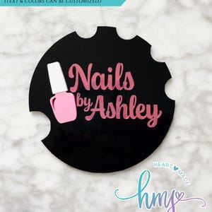 May include: Black circle with white and pink nail polish bottle icon and the text "Nails by Ashley" in pink lettering.  The text "HEARTMADE" and "hms STUDIOS" are in a blue and purple gradient.