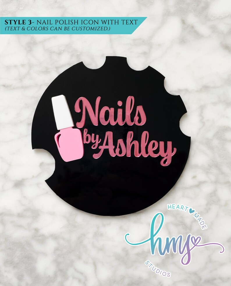 May include: Black circle with white and pink nail polish bottle icon and the text "Nails by Ashley" in pink lettering.  The text "HEARTMADE" and "hms STUDIOS" are in a blue and purple gradient.