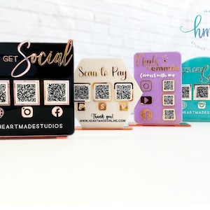 May include: Four acrylic display stands with QR codes and text. The stands are black, white, purple, and turquoise. The text on the stands reads "Let's Get Social", "Scan to Pay", "Nails by Emmie. Connect with me", and "Let's Get Social".