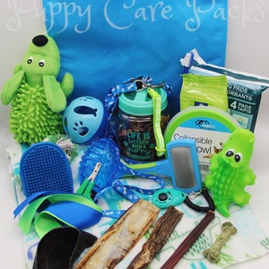 May include: A blue tote bag with the words "Puppy Care Packs" printed on it. The bag is filled with various puppy care items, including a green plush toy, a blue and green chew toy, a blue and green dog brush, a blue and green dog collar, a blue and green dog leash, a blue and green dog bowl, a green and blue dog treat jar, a green and blue dog bone, a green and blue dog toy, a green and blue dog bandana, a green and blue dog poop bag dispenser, and a green and blue dog poop bag.