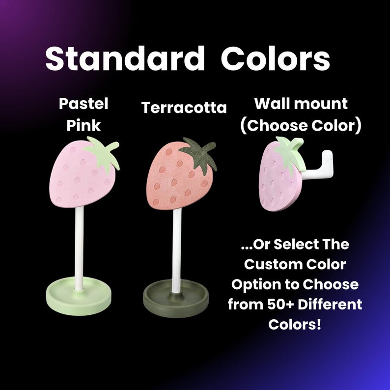 May include: Three strawberry-shaped ceramic holders for jewelry or other small items. The holders are available in pastel pink, terracotta, and a wall mount option. The text "Standard Colors" is at the top of the image. The text "Pastel Pink", "Terracotta", and "Wall mount (Choose Color)" are below the holders. The text "...Or Select The Custom Color Option to Choose from 50+ Different Colors!" is at the bottom of the image.