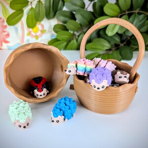 May include: A collection of small, colourful hedgehog figurines in a brown wicker basket. The hedgehogs are made of a soft, rubbery material and have different coloured spines, including rainbow, purple, and green. There is also a ladybug figurine in a separate brown basket.