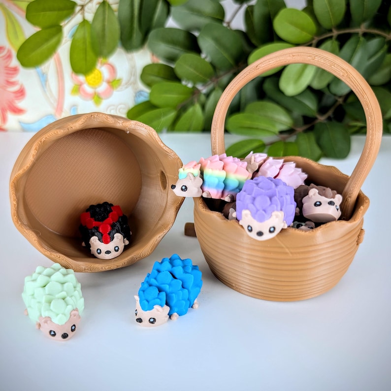 May include: A collection of small, colourful hedgehog figurines in a brown wicker basket. The hedgehogs are made of a soft, rubbery material and have different coloured spines, including rainbow, purple, and green. There is also a ladybug figurine in a separate brown basket.