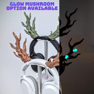 May include: A headphone stand with decorative antler-like accents. The stand holds two pairs of headphones, one black and one white. The text "GLOW MUSHROOM OPTION AVAILABLE" is displayed at the top. The right side of the image shows the glowing mushroom option.