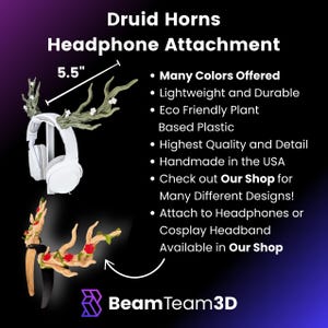 May include: Druid Horns headphone attachment, 5.5 inches wide. The image shows a pair of white headphones with a decorative antler attachment. The attachment is green and brown with red accents. Text on the image says "Many Colors Offered".