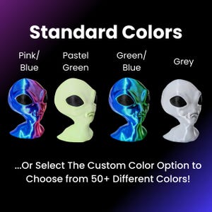 May include: Four alien head figurines in different colors: pink and blue, pastel green, green and blue, and grey. The text "Standard Colors" is at the top of the image. The text "...Or Select The Custom Color Option to Choose from 50+ Different Colors!" is at the bottom of the image.