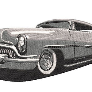 May include: A vintage silver-grey car with a chrome bumper and whitewall tires. The car has a long, sleek design with a rounded hood and a curved roofline.