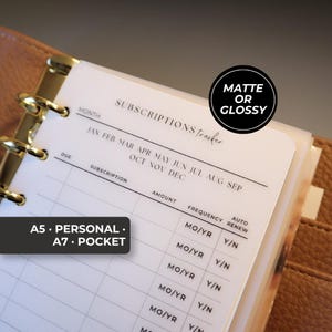 May include: A translucent subscriptions tracker planner insert with black text and grid lines. The page features columns for subscription, amount, frequency, and auto renew. Text includes "SUBSCRIPTIONS tracker", "A5 • PERSONAL • A7 • POCKET", and "MATTE OR GLOSSY".