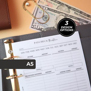 May include: A white A5 paper insert for a binder featuring a Paycheck Breakdown template with columns for income, savings, bills, fixed expenses, and sinking funds. The page includes a month selection list and a black circle with 3 DESIGN OPTIONS.