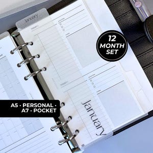 May include: A planner insert set featuring translucent dividers with the text January, daily planning pages with sections for priorities and notes, and a 12 month set label. The pages are held by silver metal rings in a black binder.