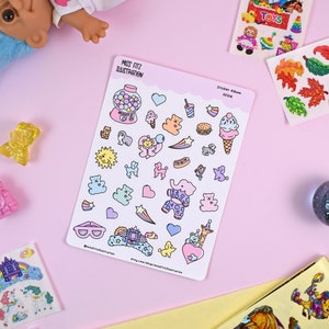 Könnte beinhalten: Ein Blatt mit bunten Aufklebern mit verschiedenen niedlichen Illustrationen, darunter ein Gummibärchenautomat, ein Bär, ein Elefant, ein Hund, ein Herz, ein Stern, eine Wolke, ein Regenbogen, ein Schloss und ein Einhorn. Die Aufkleber sind perfekt, um Ihrem Planer, Tagebuch oder Sammelalbum einen Hauch von Verspieltheit zu verleihen.