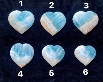 May include: Six heart-shaped blue and white agate stones, numbered 1 through 6. The stones are arranged in two rows of three, with the numbers above each stone.