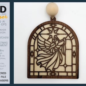 May include: A two-layer wooden ornament featuring an arched frame with a cutout design of an angel playing a trumpet beneath a star. The dark wood overlay sits atop a light wood base, topped with a round wooden bead for hanging.