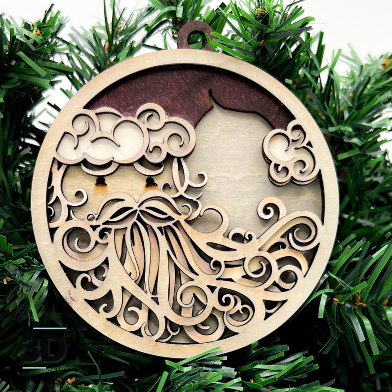 May include: A wooden Christmas ornament featuring a detailed cutout design of Santa Claus's face with a beard and clouds. The ornament is circular and has a brown stain on the back.
