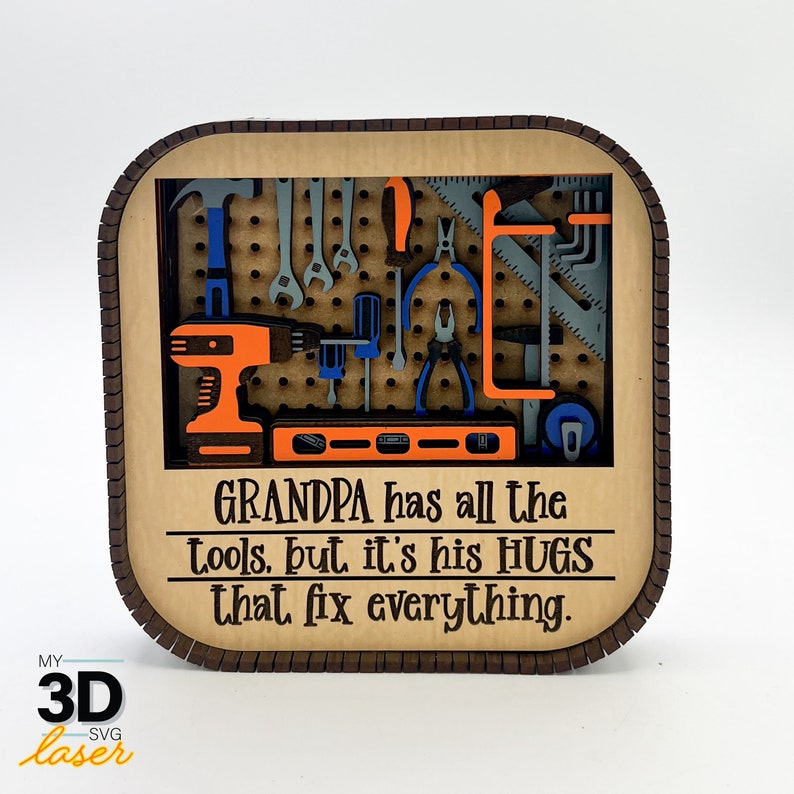 May include: A wooden sign with a tool-themed design. The sign features a pegboard with various tools, including a drill, a level, and spanners. The text on the sign reads "GRANDPA has all the tools, but it's his HUGS that fix everything."