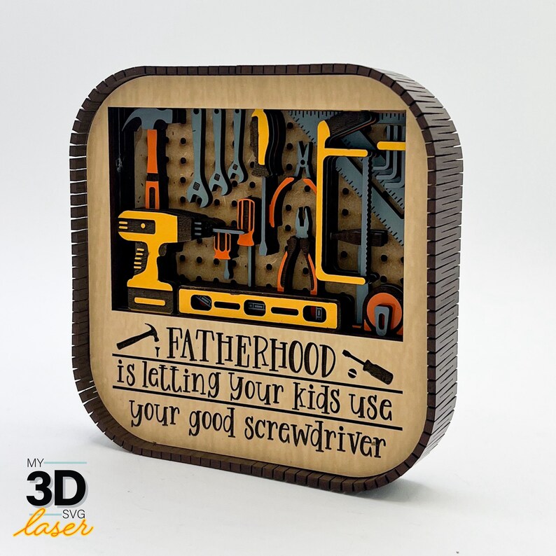May include: A brown wooden sign with a cutout of a tool rack with various tools. The sign reads "Fatherhood is letting your kids use your good screwdriver."