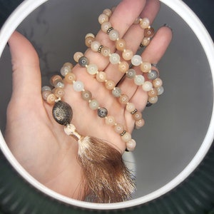 Feminine Divine Mala with Moonstone featuring two vintage Rhodochrosite beads, Navajo Pearls, and a Bali Silver Guru. GORGEOUS!