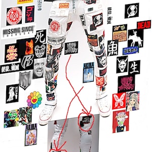 May include: White jeans with various patches and graphics, including logos, cartoon characters, and Japanese text. The jeans are ripped and distressed, with visible stitching and frayed edges.