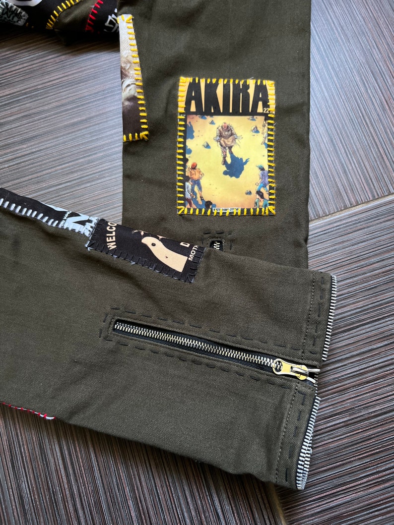 May include: Green pants with a zipper on the side and various patches sewn on, including one with the word "AKIRA" on it.