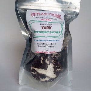 May include: A silver resealable bag containing six freeze-dried peppermint patties. The bag has a label that reads "Outlaw Foodie" and "Freeze Dried York Peppermint Patties".