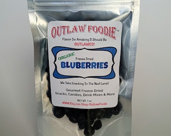 May include: A silver resealable pouch containing freeze-dried organic blueberries. The pouch has a label that reads "Outlaw Foodie" and "Flavor So Amazing It Should Be Outlawed!" The label also states "Freeze Dried Blueberries" and "We Take Snacking To The Next Level! Gourmet Freeze Dried Snacks, Candies, Drink Mixes & More. NET WT 1 oz. WWW.Etsy.com/Shop/OutLawFoodie"