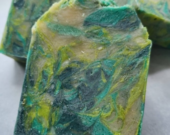 May include: Three bars of handmade soap with a green, blue, and white marbled swirl pattern.