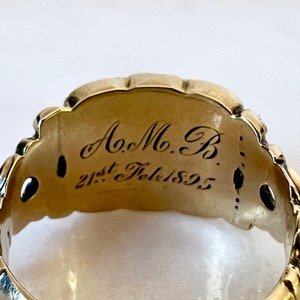 May include: A gold ring with an inscription that reads "A.M.B. 21st Feb. 1892".