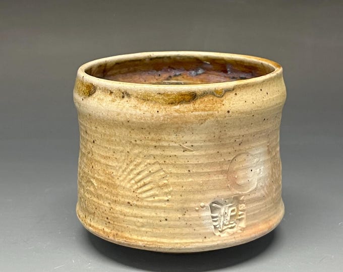 Wheel thrown stoneware Cup that is wood fired and Salt Glazed