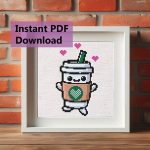 May include: Cross stitch pattern featuring a cartoon coffee cup with a heart on the cup and surrounded by pink hearts. The pattern is in a white frame on a brick background. The text "Instant PDF Download" is in a purple box above the frame.