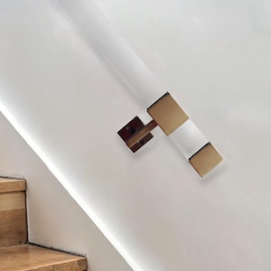 May include: A wooden staircase with a white wall and a brushed nickel handrail with a clear glass insert.