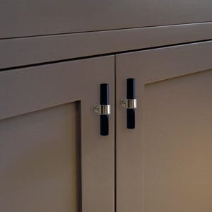 May include: Two cabinet doors with black and silver rectangular cabinet pulls.