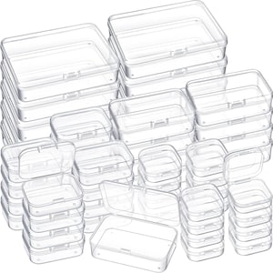 May include: A set of 30 clear plastic storage boxes of various sizes. The boxes are stacked and arranged in a random pattern. The boxes are ideal for organizing small items, such as jewelry, craft supplies, or office supplies.