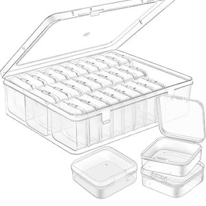 May include: A clear plastic storage box with a hinged lid and 24 individual compartments. The box is open and the lid is propped up. There are three smaller clear plastic boxes with lids stacked on top of each other.