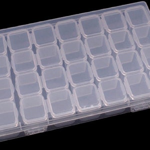 May include: A clear plastic storage box with 30 individual compartments. The box is ideal for organizing small items like beads, buttons, or jewelry.