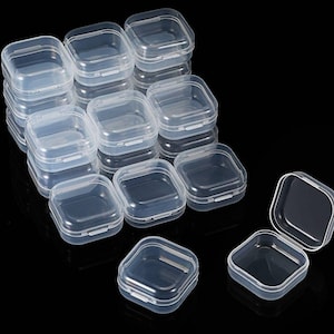 May include: A set of 15 clear plastic square storage containers. The containers are stacked in a pyramid shape with one container open.