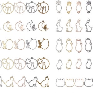 May include: Assortment of metal blank charms in various shapes and sizes, including cats, rabbits, moons, stars, and eggs. The charms are in silver, gold, and rose gold tones.