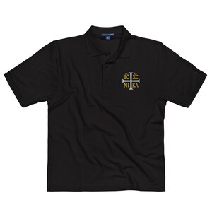 May include: Black polo shirt with a white embroidered cross and the text "IC XC NIKA" in gold.