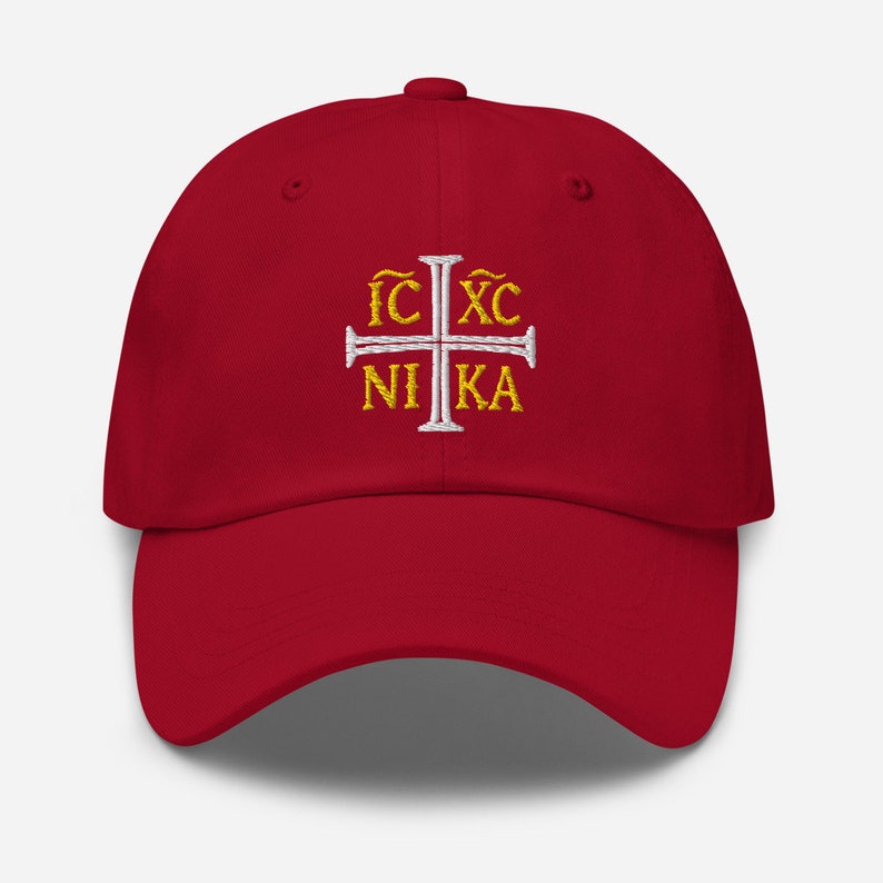 May include: Red baseball cap with a white cross and the text "IC XC NIKA" embroidered in gold.