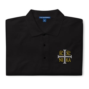 May include: Black polo shirt with a white embroidered cross and the text "IC XC NI KA" in gold lettering.