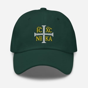 May include: A dark green baseball cap with a white cross and the text "IC XC NIKA" embroidered in gold.