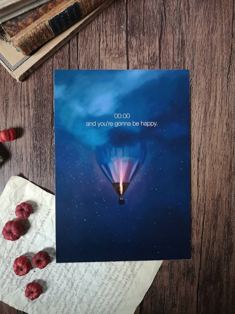 May include: A blue and white hot air balloon with a glowing orange flame ascends into a dark blue night sky with stars. The text "00:00 and you're gonna be happy." is written in white.