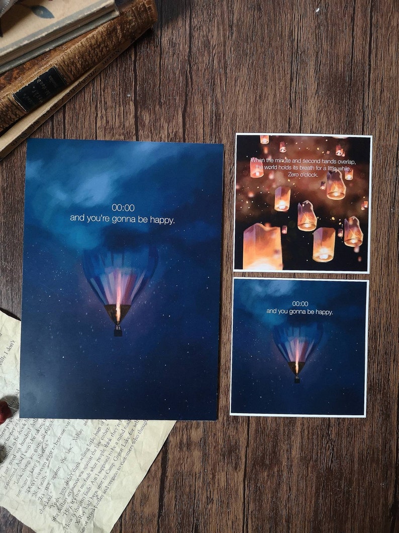 May include: Two printable cards with a blue night sky background and a hot air balloon. The text on the cards reads "00:00 and you're gonna be happy".