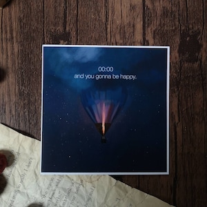 May include: A dark blue background with a hot air balloon floating in the sky. The balloon is glowing orange and purple. The text "00:00 and you gonna be happy." is displayed at the top of the image.